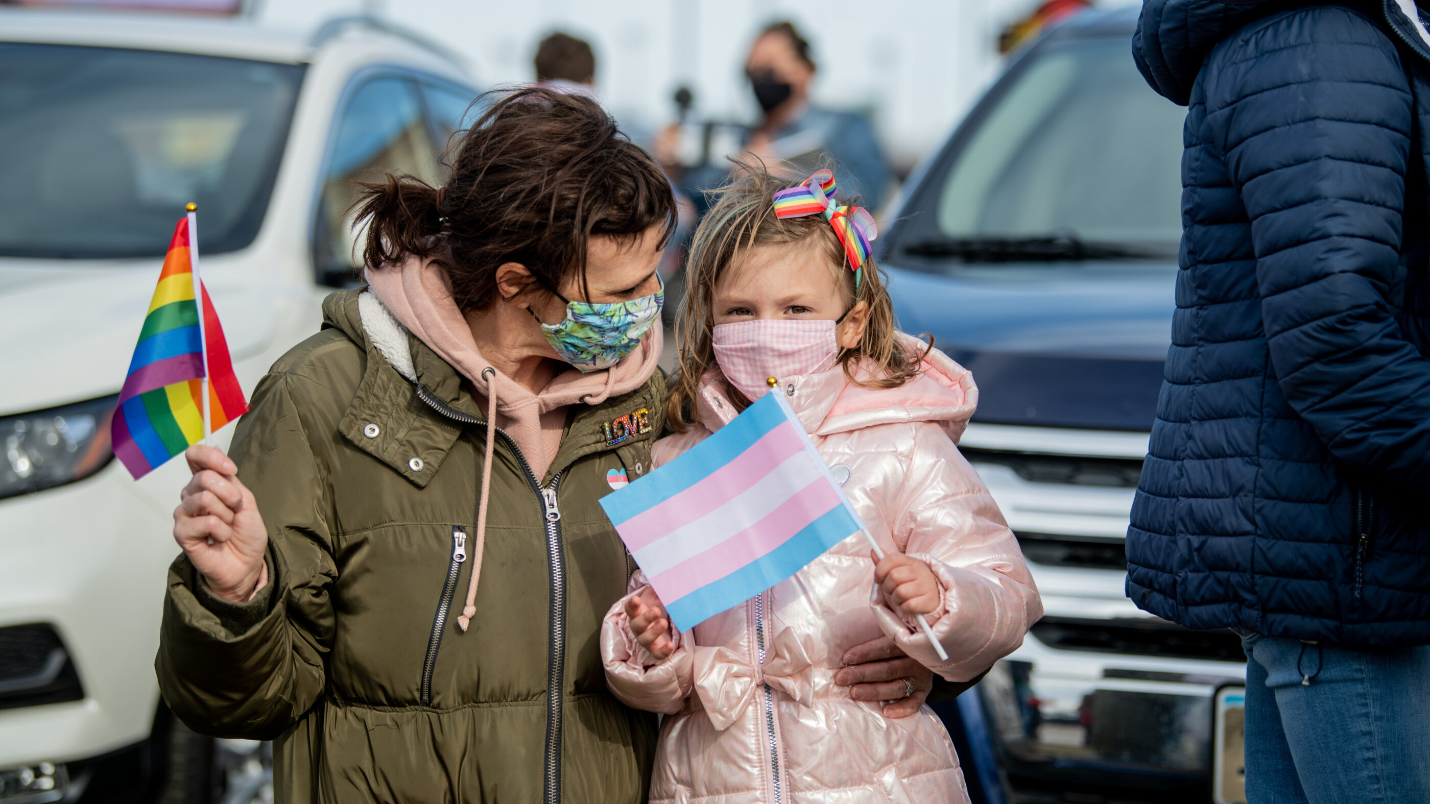 Image of a mother and their child holding flags