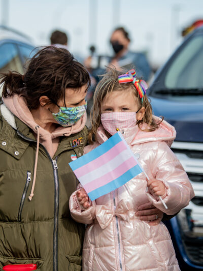 Image of a mother and their child holding flags