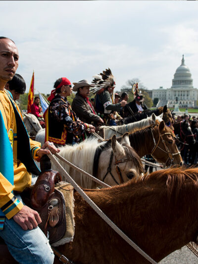 Native Americans on horse back protesting at Capitol Hill