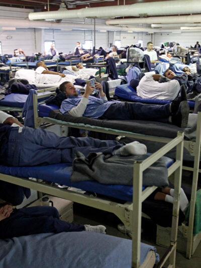 A room full of inmates are seen in their bunk beds