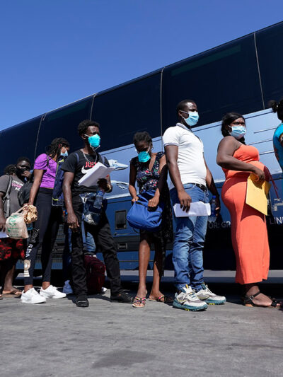 Migrants, many from Haiti, board a bus after they were processed and released after spending time at a makeshift camp near the International Bridge, Monday, Sept. 20, 2021, in Del Rio, Texas.
