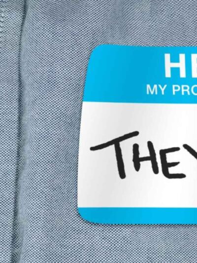 Image of a shirt with a pronoun tag that reads, "they/them"