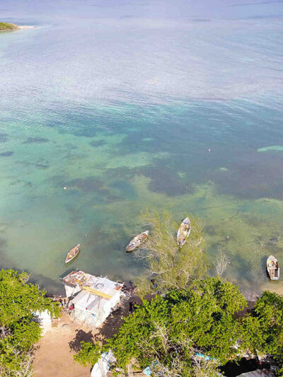 An overhead photograph of the ocean, dotted with boats.