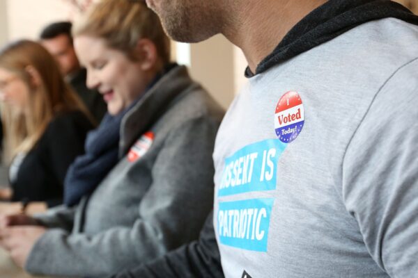 Person with an "I voted" sticker on their shirt.