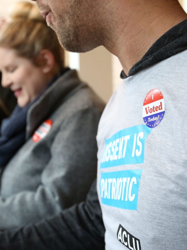 Person with an "I voted" sticker on their shirt.