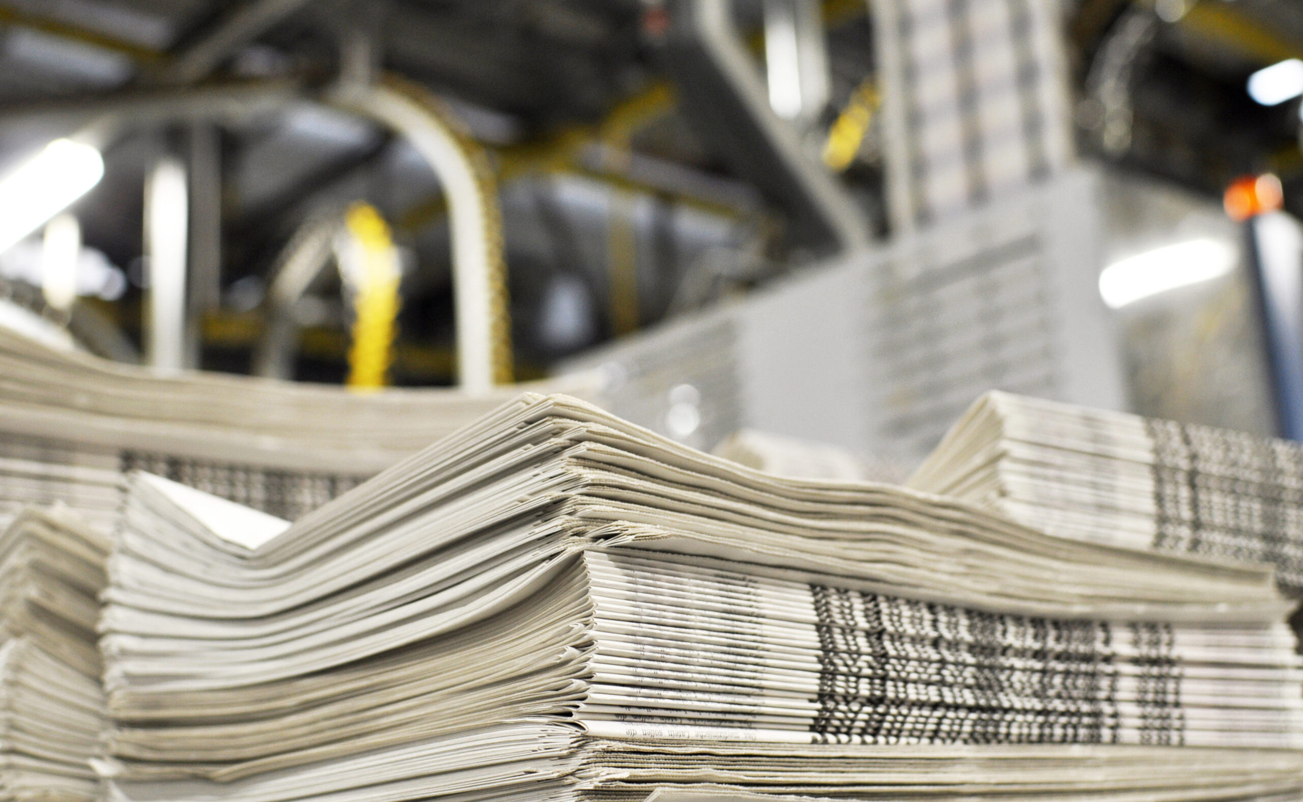 Image of a stack of newspapers in a warehouse