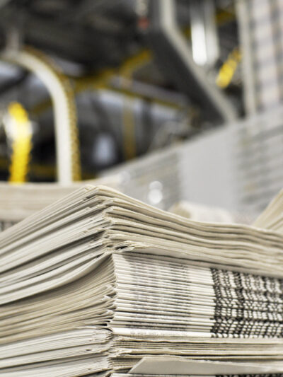 Image of a stack of newspapers in a warehouse