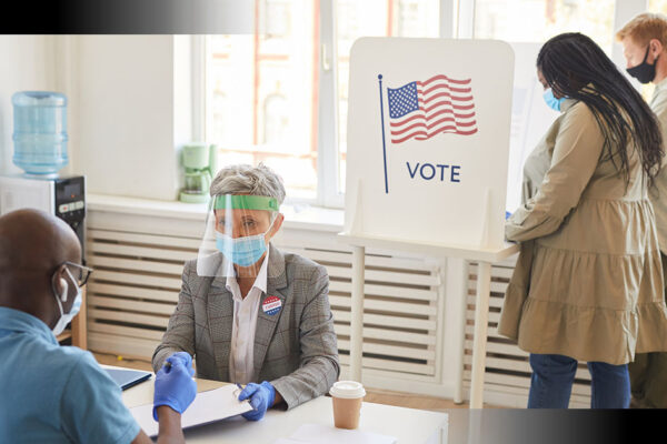 Image of poll workers helping people vote