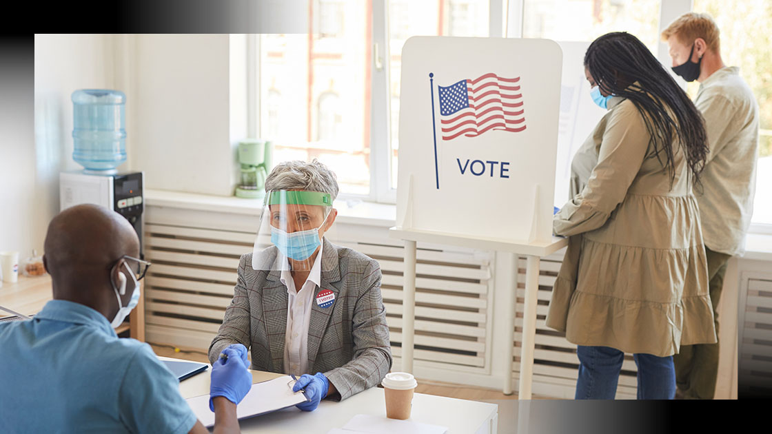 Image of poll workers helping people vote