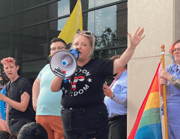 Person speaking at a protest in North Dakota.