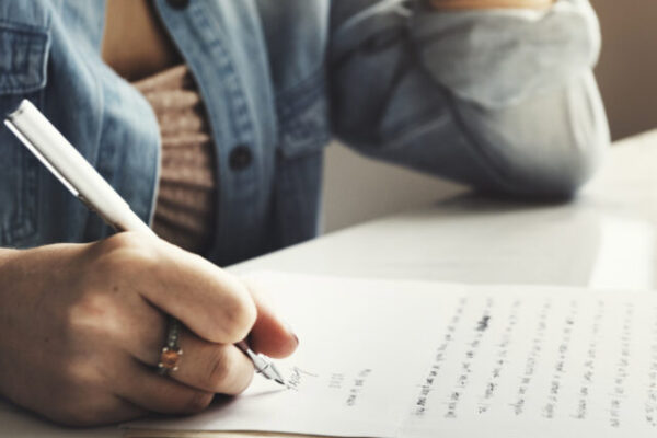 Person writing a letter