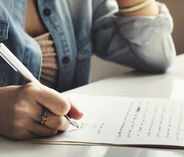 Person writing a letter