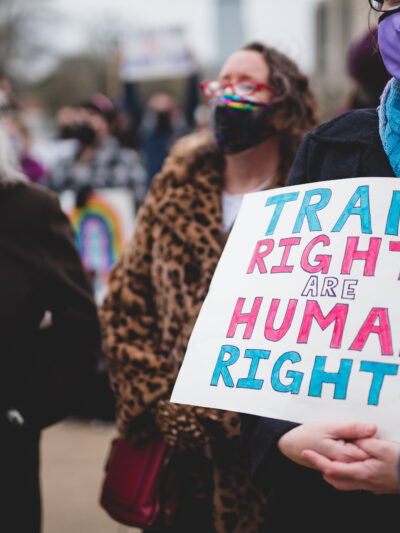 Trans Rights Are Human Rights protest sign held by someone at a rally.