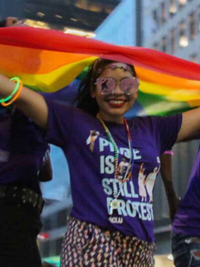 Person wearing a "Pride is still protest" t-shirt