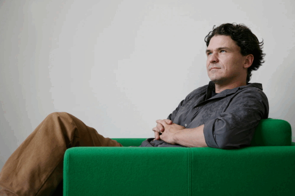 Dave Eggers in a green chair