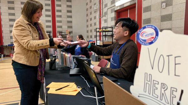 poll worker helping a voter
