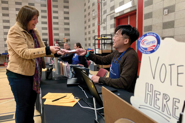 poll worker helping a voter