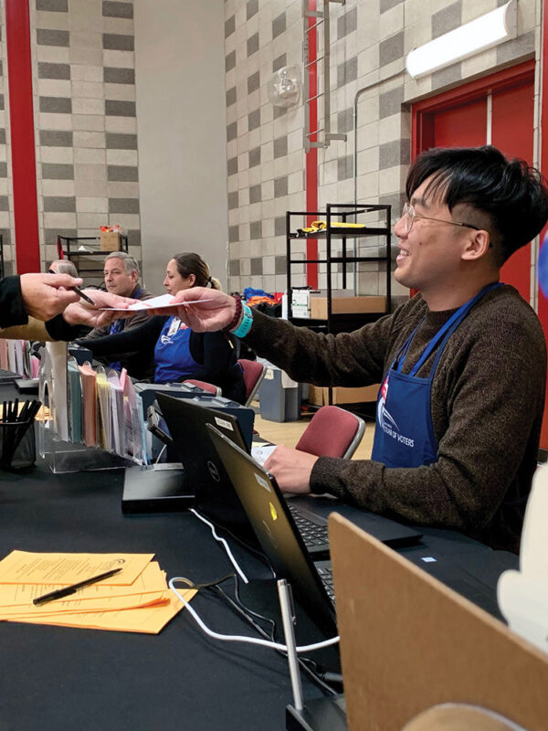 poll worker helping a voter