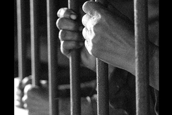 Hands behind bars.