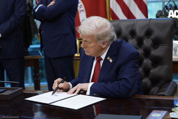 President Donald Trump signing a document