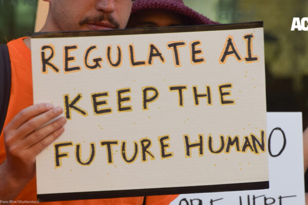 Sign that says "Regulate AI, keep the future human"