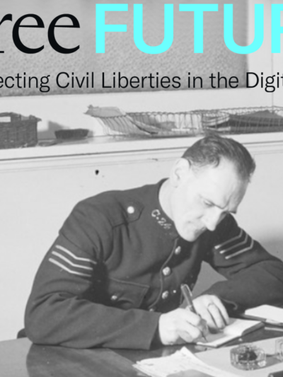Black and white photo of a police officer sitting at a desk writing by hand