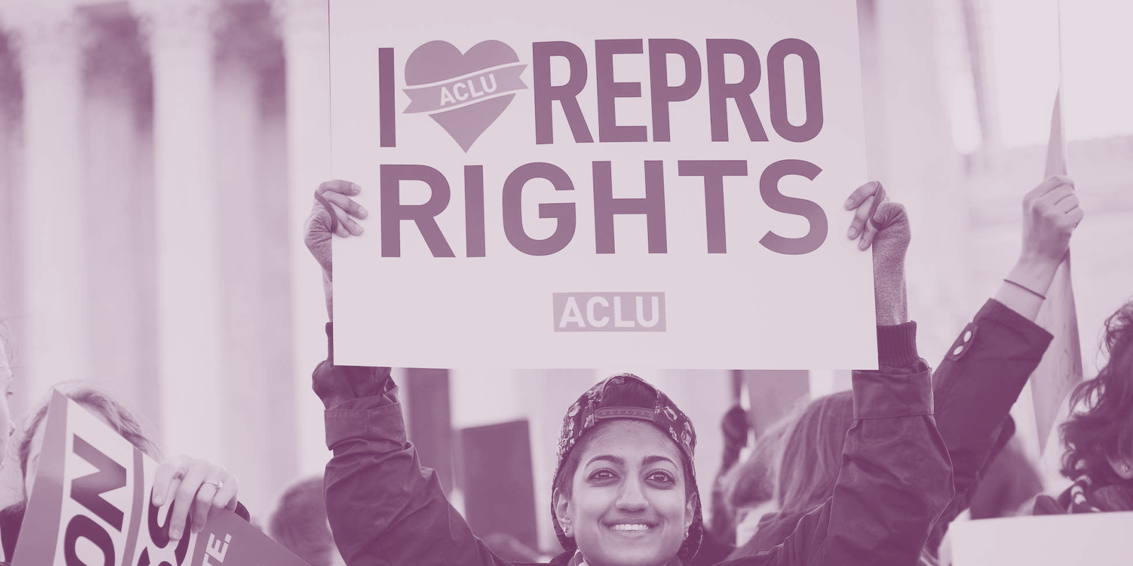 image of a person holding a sign that reads, "I love repro rights."