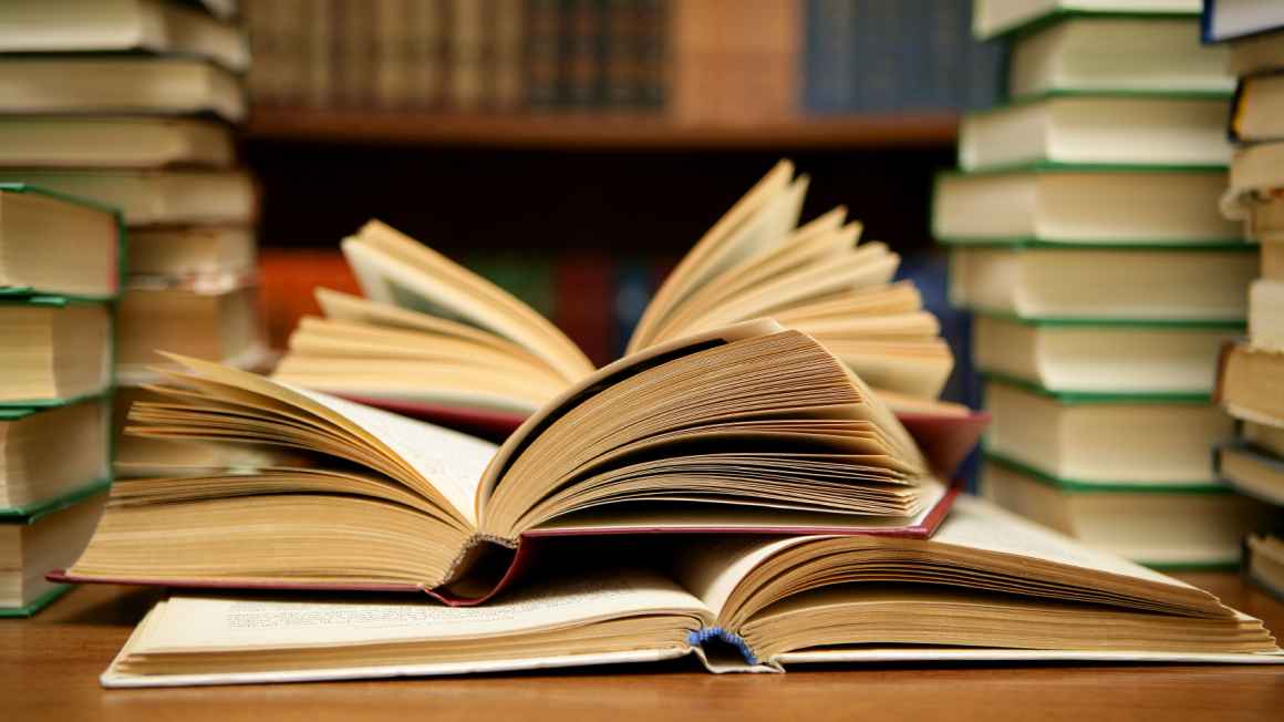 Several books open on a table