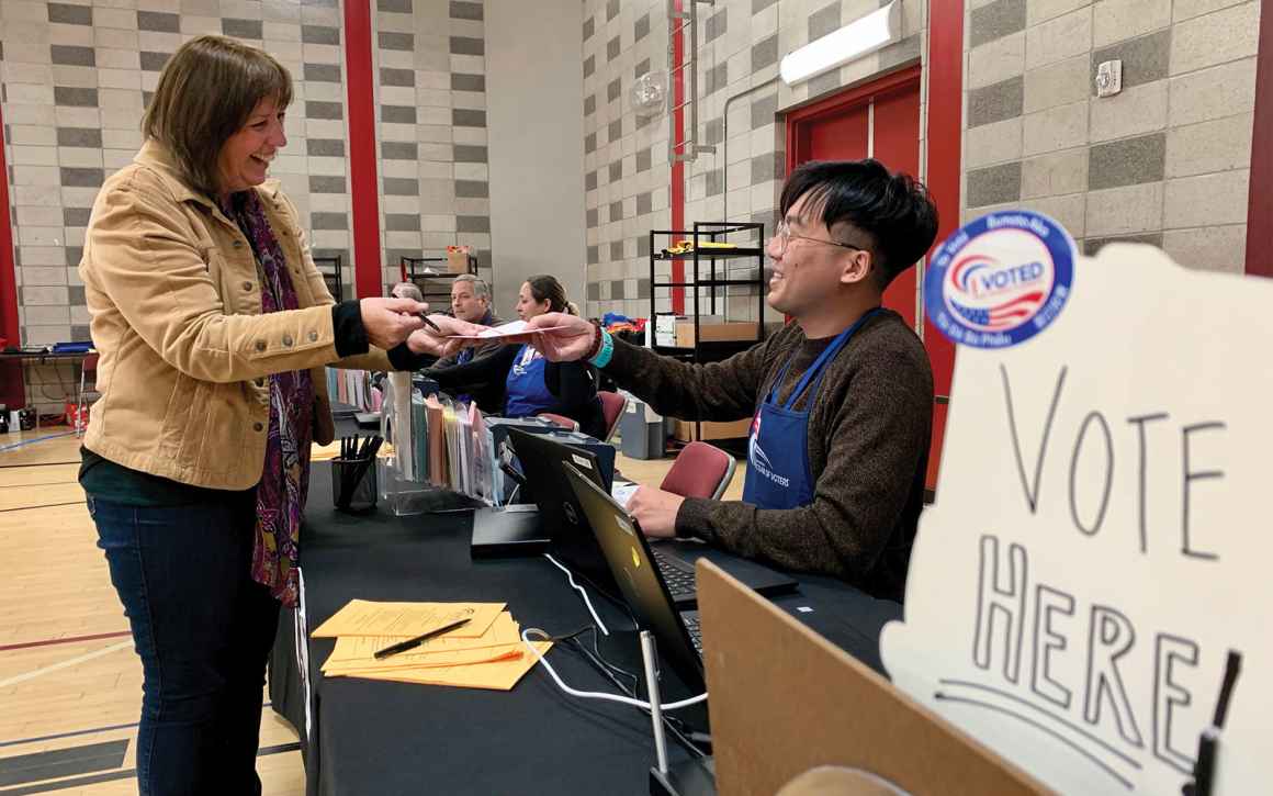 poll worker helping a voter