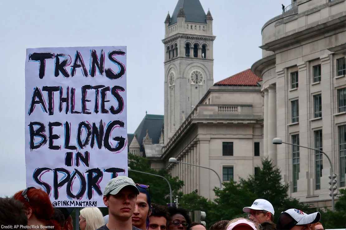 Image of a protest sign that reads "Trans athletes belong in sports"