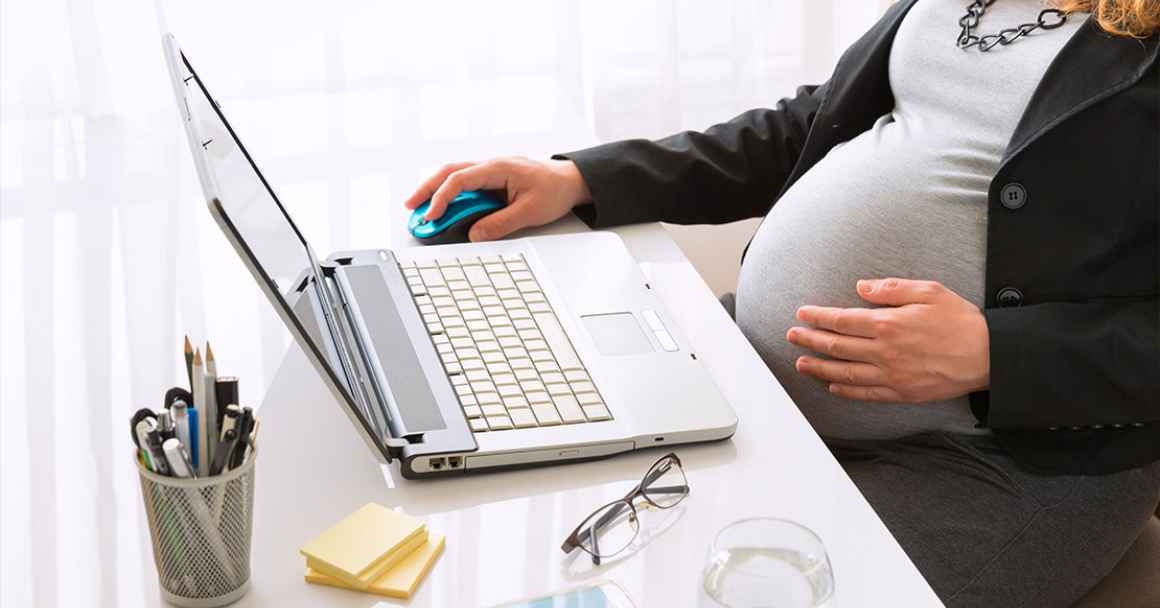 Pregnant woman working at the office