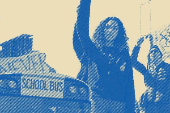 Image of a school bus with students protesting near it