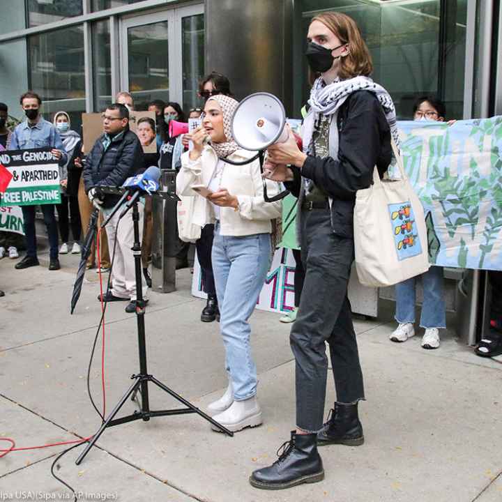 Individuals from Students for Justice in Palestine speak at the Boot Boeing! Free Palestine march and rally while they block all the entrances to Governor Pritzker's Chicago office in downtown Chicago.