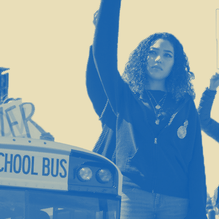 Image of a school bus with students protesting near it